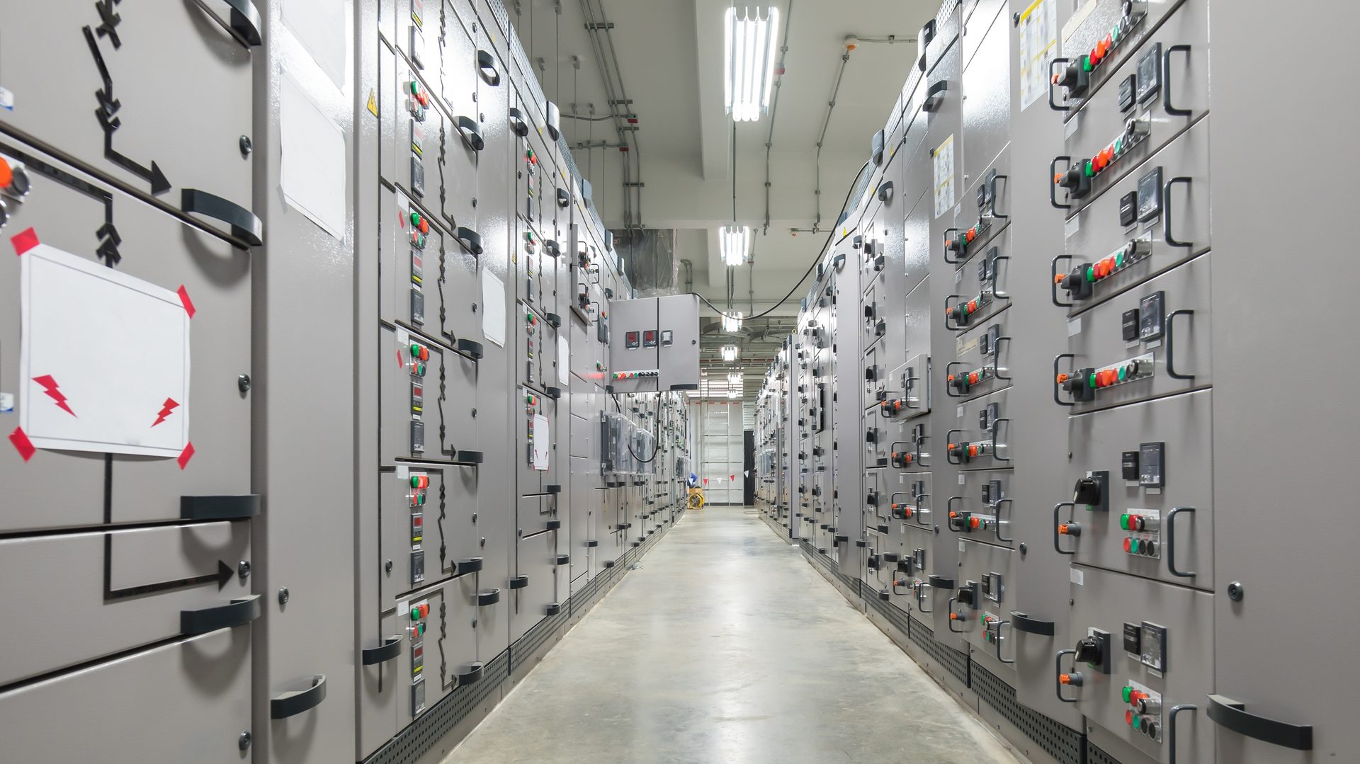 SMEC engineers assembling and wiring an industrial control panel in the fabrication facility